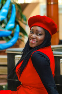 Smiling woman in a red beret and red dress