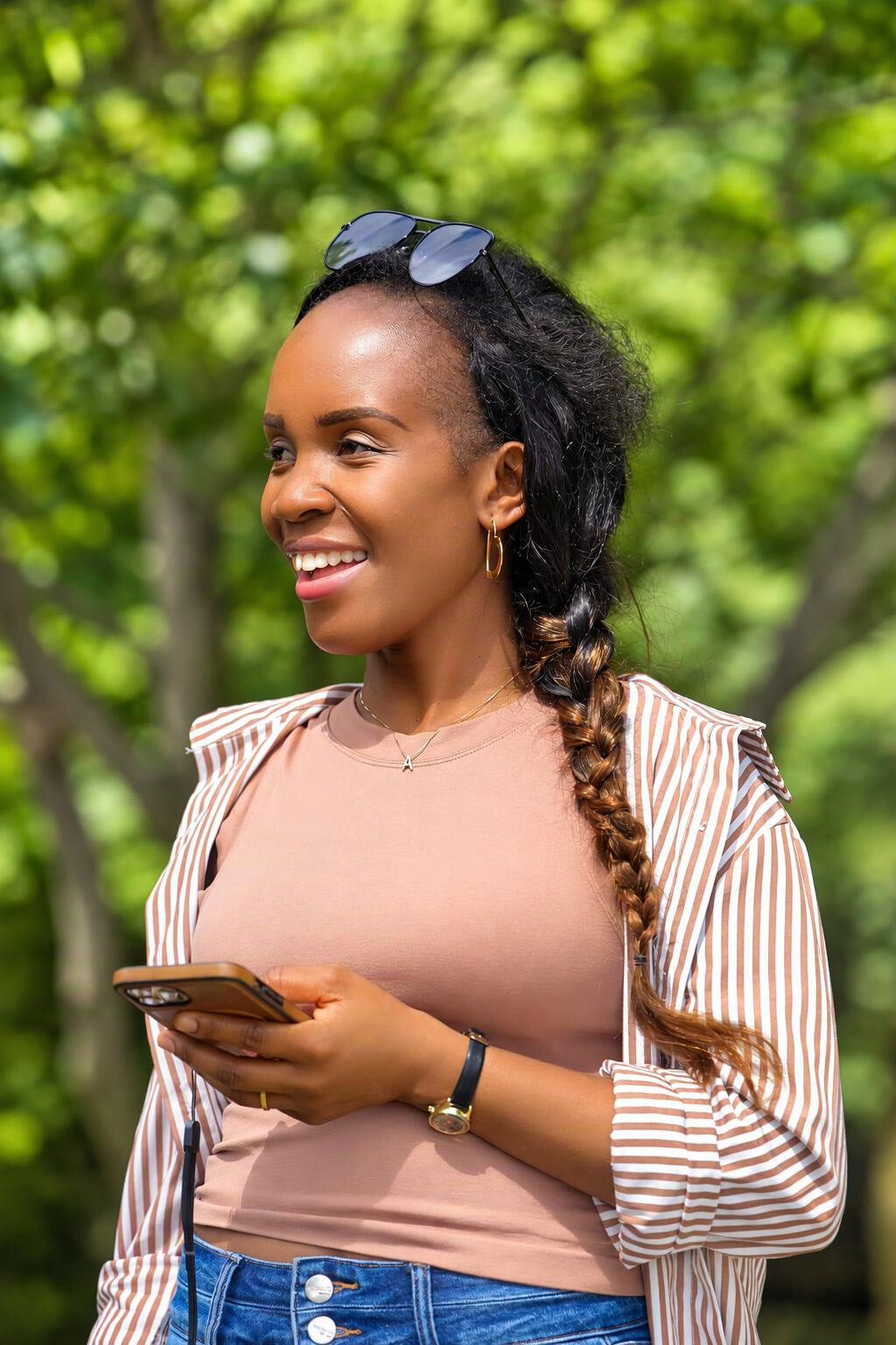 Woman smiling while texting outdoors