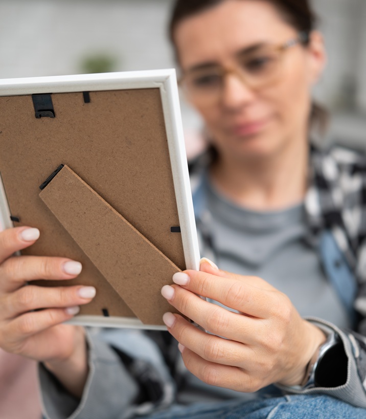 Woman holding a framed photo print at home